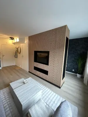 a living room with a couch and a fireplace at Modern apartment ONLY 5 minutes from City centre in Bergen