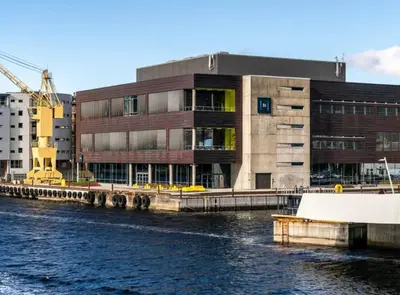 a building next to a body of water at Modern apartment ONLY 5 minutes from City centre in Bergen