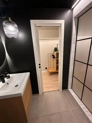 a bathroom with a sink and a mirror at Newly Renovated Rom Bergen Fana in Bergen