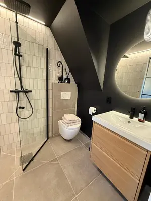 a bathroom with a shower and a toilet and a sink at Newly Renovated Rom Bergen Fana in Bergen