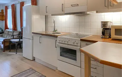 a kitchen with a white stove and a sink at Stunning Home In Eidsvåg I Romsdal in Toven