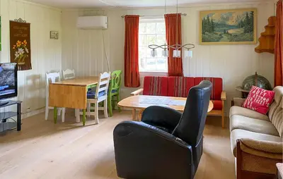 a living room with a table and a dining room at Stunning Home In Eidsvåg I Romsdal in Toven
