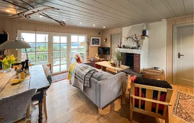 a living room with a couch and a table at 2 Bedroom Cozy Home In Sjusjøen in Sjusjøen