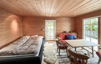 a bedroom with a bed and a table in it at 2 Bedroom Cozy Home In Sjusjøen in Sjusjøen