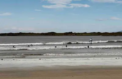 a group of people in the water at the beach at Atlantis cabin with sauna and great views in Vevang