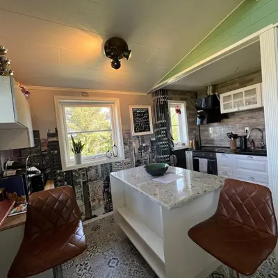 a kitchen with a counter and a sink in it at Atlantis cabin with sauna and great views in Vevang