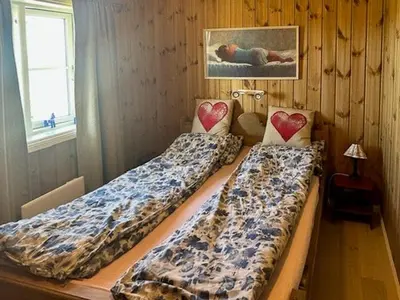 a room with two beds in a room with a window at Modern Cabin With Views In Lygna in Jaren