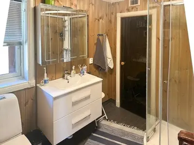 a bathroom with a white sink and a shower at Modern Cabin With Views In Lygna in Jaren