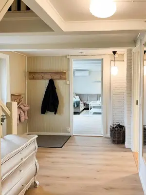 a hallway with a door leading to a bedroom at Hyggelig Gård Nær Bergen Med Spabad in Hjelmås