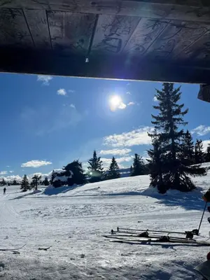 a group of skis sitting on a snow covered slope at Koselig, lita hytte på Aurdalsåsen ved Danebu in Aurdal