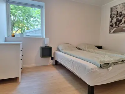 a bedroom with a bed and a window at Fjord Nest in Bergen