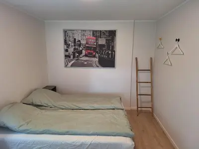 a bedroom with a bed and a red double decker bus at Fjord Nest in Bergen