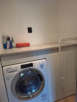 a washing machine in a room with a counter at Fjord Nest in Bergen