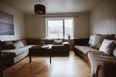 a living room with a couch and a table at Location, location, location in Ervik