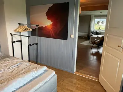 a bedroom with a tv hanging on the wall at Location, location, location in Ervik