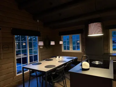 a kitchen with a table and chairs in it at No 105 Kongelberget in Bjorli