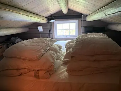 a bedroom with a bed with pillows and a window at No 105 Kongelberget in Bjorli