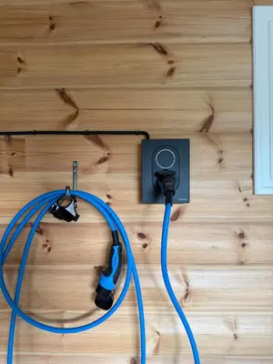 a blue cord plugged into an outlet on a wall at No 105 Kongelberget in Bjorli