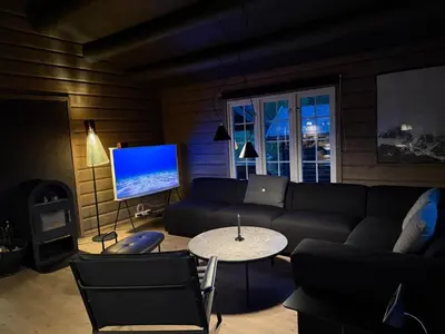 a living room with a couch and a table and a tv at No 105 Kongelberget in Bjorli