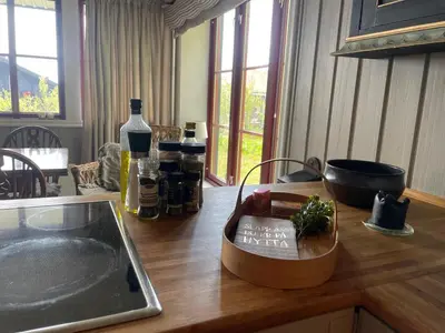 a kitchen counter with bottles of wine on a table at Nice And Central With Terrace in Beitostøl