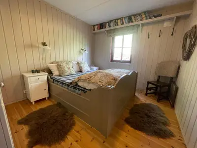 a bedroom with a bed in a room with two rugs at Nice And Central With Terrace in Beitostøl