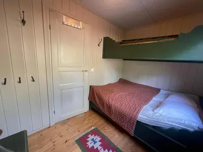 a small bedroom with a bed and a closet at Nice And Central With Terrace in Beitostøl