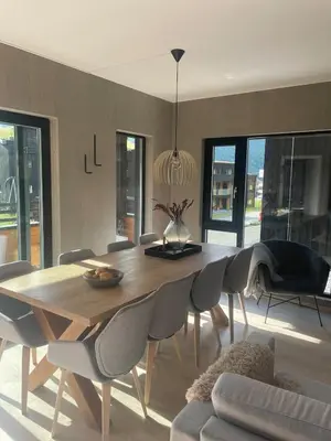 a dining room with a wooden table and chairs at Familiy apartment in Myrkdalen Voss in Vossestrand