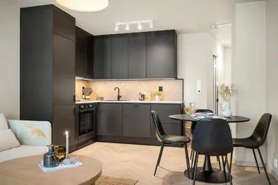 a kitchen and a living room with a table and chairs at Central apt in the centre of Bergen in Bergen