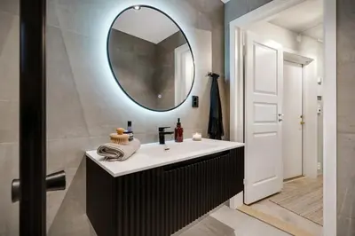 a bathroom with a sink and a mirror at Central apt in the centre of Bergen in Bergen