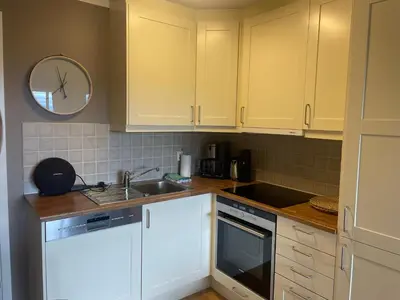 a kitchen with white cabinets and a sink at Central, Cozy & Pet-Friendly in Beitostøl