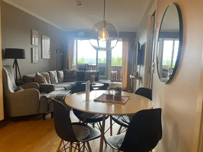 a living room with a table and chairs at Central, Cozy & Pet-Friendly in Beitostøl