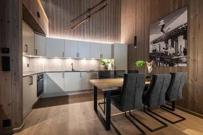 a kitchen with a wooden table and chairs at Penthouse with large rooftop terrace, Ski In-Ski Out in Hemsedal in Hemsedal