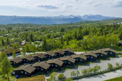 an aerial view of a row of houses in the mountains at Bitigrenda M in Beitostøl