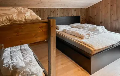 two bunk beds in a room with wooden walls at Cozy Home In Hovden I Setesdal - With Jacuzzi in Hovden