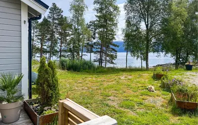 a yard with a view of the water at 2 Bedroom Stunning Home In Lavik in Lavik