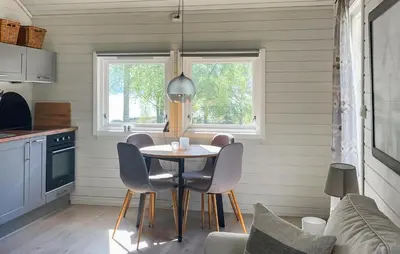 a kitchen with a table and chairs in a room at 2 Bedroom Stunning Home In Lavik in Lavik