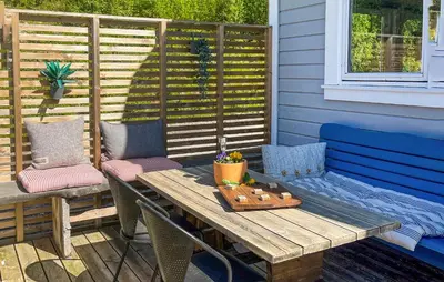 a wooden table and chairs on a patio at 2 Bedroom Stunning Home In Lavik in Lavik