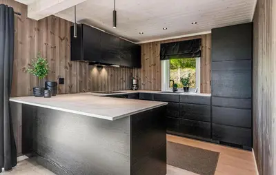 a kitchen with black cabinets and a counter top at Amazing Home In Ål - With Wifi in Ål