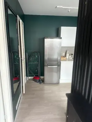 a kitchen with a stainless steel refrigerator in a room at Cozy little apartment in Ålesund in Ålesund