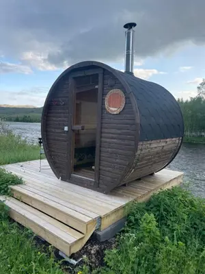 a round cabin on a dock on a body of water at River Glamping - Jordet, Trysil in Trysil