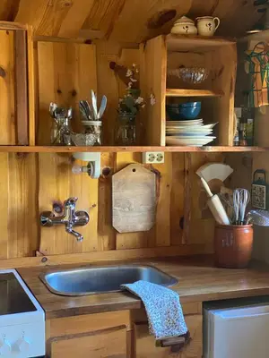 a kitchen with a sink in a wooden kitchen at Cabin in Oppstryn in Stryn