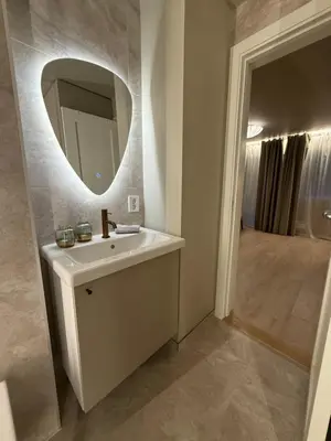 a bathroom with a sink and a mirror at New Modern Apartment Near Tram Fantoft in Bergen