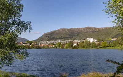 a view of a lake with mountains in the background at New Modern Apartment Near Tram Fantoft in Bergen
