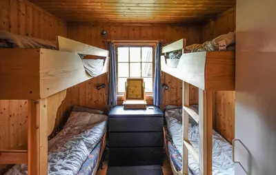 a room with two bunk beds in a cabin at Awesome Home In Uvdal With Sauna in Uvdal