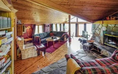 a living room with a couch and a fireplace at Awesome Home In Uvdal With Sauna in Uvdal