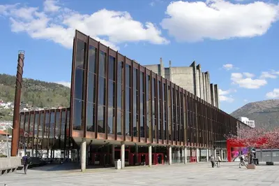 a large building with windows on a city street at Cozy Gem in the Heart Of Bergen in Bergen