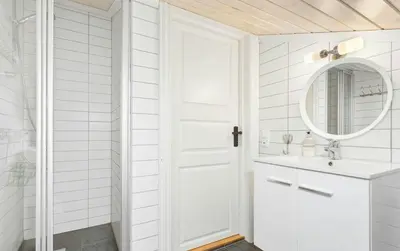 a white bathroom with a sink and a mirror at Family Cabin With Jacuzzi At Tempelseter in Eggedal