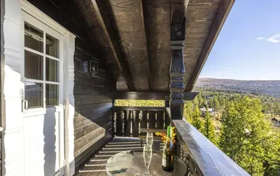 a balcony with a table and a view at Family Cabin With Jacuzzi At Tempelseter in Eggedal