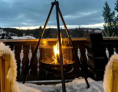 a fire in a basket in the snow at Spacious Family Cabin At Nesfjellet With Views in Nesbyen