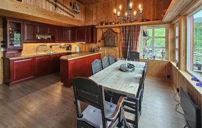 a large kitchen with a wooden table and chairs at Cozy Home In Hemsedal With Sauna in Hemsedal